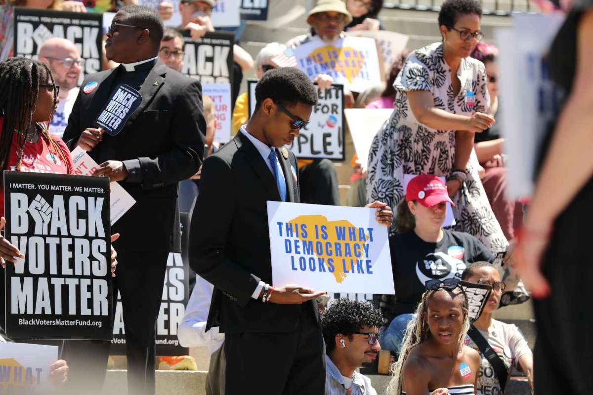 People gathered on the steps of the South Carolina Statehouse holding signs, such as "This Is What Democracy Looks Like" and "Black Voters Matter"