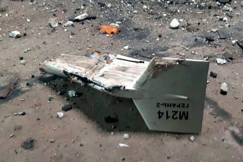 A fragment of a drone rests on the ground