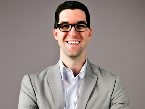 Headshot of Mark Coleman McClinton in a tan suit