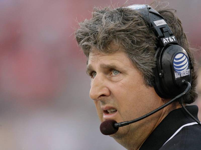 A close up of a man wearing a headset in a sport setting