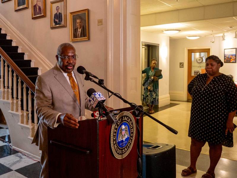 Jackson Mayor John Horhn speaks from a podium in Jackson City Hall.